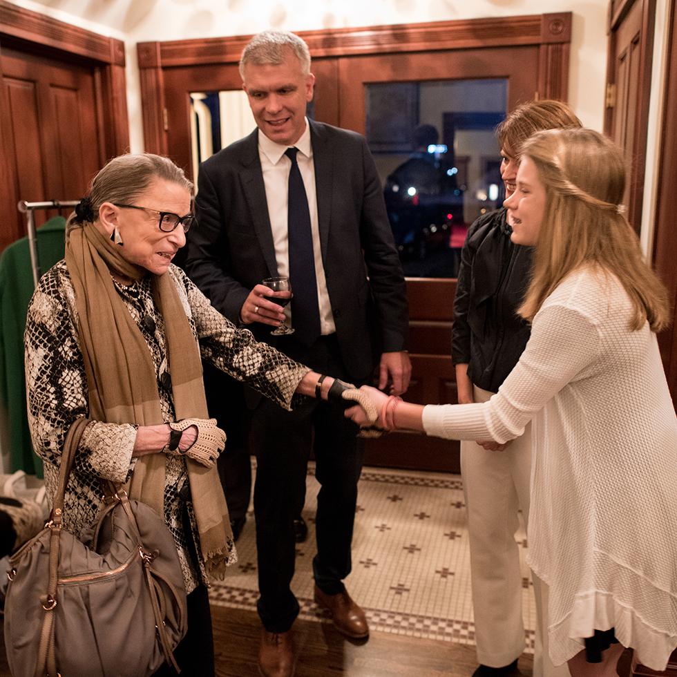 A student shakes Ruth Bader Ginsburg's hand