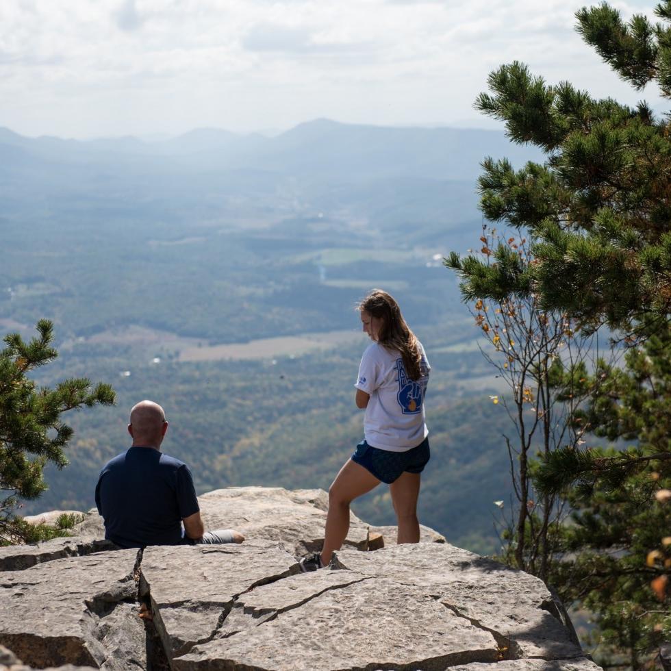 students atop a mountain overlooking the valley